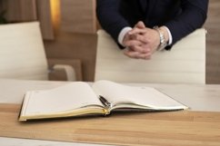 hands of a businessman in a dark blue suit and diary Product Image 1