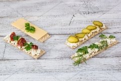 various crispbread slices on white wooden kitchen table Product Image 1
