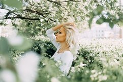 Beautiful young blonde girl in blooming Apple orchard. Product Image 1