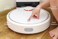 kids hand press button to turn the robot vacuum cleaner on Product Image 1