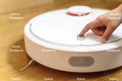 kids hand press button to turn the robot vacuum cleaner on Product Image 1