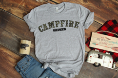 Outdoor humor PNG design featuring camouflage varsity lettering spelling “Campfire” with “Drunk” below in a black badge. Rustic camp themed graphic for shirts, sublimation, and DIY apparel.