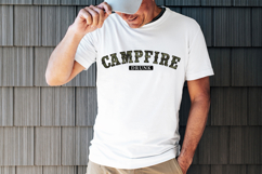 Distressed camo camp lettering design that reads “Campfire Drunk” in a vintage college style arch font with bold outlines, ideal for camping shirts, lake trip apparel, and outdoor humor graphics.