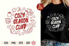 Cozy Season Club SVG PNG design with fall leaves, acorns, candle, and PSL cup displayed on a black t-shirt mockup