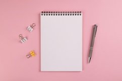 Open notebook with blank sheet, paper clips and pen Product Image 1