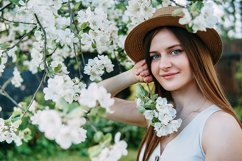 Beautiful young girl in hat in blooming Apple orchard. Product Image 1