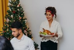 A swarthy girl is carrying a festive turkey Product Image 1