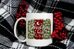 christmas png design on a red and green pattern background with a phrase Christmas is here on a white  mug
