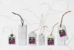 colorful christmas sublimation design on 4 light grey gift tags