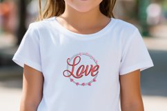 Circle of love embroidery design featured on white t-shirt worn by a girl. This is a inspiration photo showing how this embroidery pattern can be used.