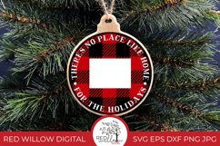 Round buffalo plaid Christmas Ornament design for Colorado with the phrase &quot;there's no place like home for the holidays&quot; displayed on a wood ornament hung from a Christmas tree. 