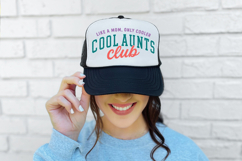 Graphic design mockup showing a “Cool Aunts Club” phrase in vibrant colors. The layout is balanced with arched text and script detail for a stylish finished product.