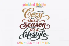 A hand-lettered digital cut file celebrating cozy season with flowing script, dramatic swashes, and warm autumn colours including mustard, rust, burgundy, and olive.