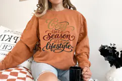 Digital craft design with the wording “Cozy isn’t a season it’s a lifestyle” in decorative script. Large lettering and sweeping flourishes create a warm, playful fall look.