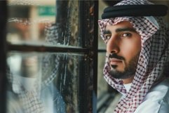 Thoughtful man in traditional arabic attire Product Image 1