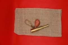 key chain and a red stone on the Mat Product Image 1