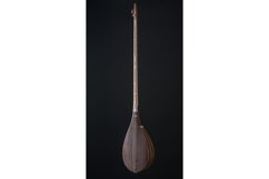 Ancient Asian stringed musical instrument on black Product Image 1