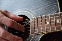 Playing the Wooden Acoustic Guitar Product Image 1