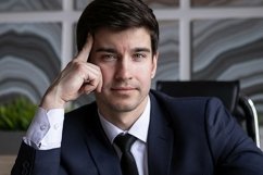 portrait of a businessman in a dark blue suit in the office Product Image 1