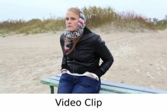 Video: Young girl is sitting on a bench near the sea Product Image 1