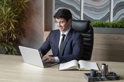 portrait of a businessman in a dark blue suit in the office Product Image 1