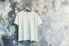 mockup plain white t-shirt hanging on a cement wall Product Image 1