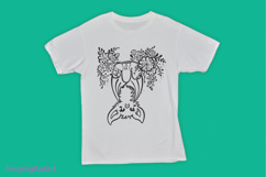 A white t-shirt featuring a cute, cartoon-style bat hanging upside down with fluffy fur and large ears. The bat is surrounded by floral designs, creating a whimsical black and white graphic on the shirt. The background is a bright teal color.