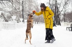 Beautiful smiling young woman is playing with her dog. Product Image 1