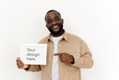 Black man holding a horizontal white blank board for design Product Image 1