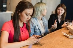 Portrait of Asian woman surfing the internet in the cafe Product Image 1