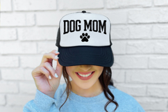 Modern dog mom shirt design featuring large black lettering and a centered paw print. The texture appears slightly worn, creating a trendy rustic aesthetic for DIY apparel.