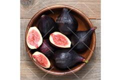 Ripe figs in wooden bowl close-up Product Image 1