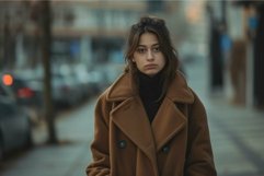 Pensive woman in brown coat on city street Product Image 1