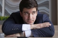 portrait of a businessman in a dark blue suit in the office Product Image 1