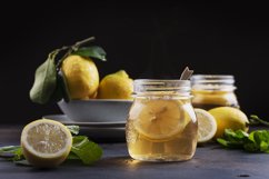Hot lemon tea with mint on the black table Product Image 1