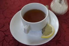 Black tea in a red mug on the table Product Image 1