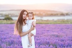 Beautiful woman holding little baby girl in lavender field Product Image 1
