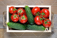 Tomatoes and cucumbers in wooden box close-up Product Image 1