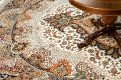Part of an antique table on a decorated oriental carpet Product Image 1