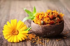 Dried and fresh marigold flowers in a bowl on wooden table Product Image 1