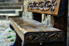 Old ornamented wooden bench standing in front of stone steps Product Image 1