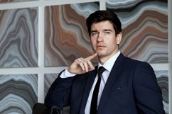 portrait of a businessman in a dark blue suit in the office Product Image 1