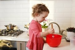 happy child girl preparing cookies in the kitchen Product Image 1