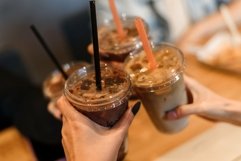 Close up image of multiethnic people clinking coffee glasses Product Image 1