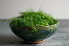 Fresh dill in ceramic bowl on kitchen counter Product Image 1