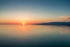 Sunset over a calm sea from the height of bird flight Product Image 1