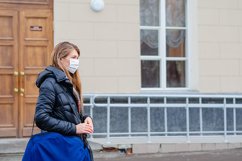 woman wears medical mask in the empty street. Product Image 1