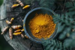 Vibrant turmeric powder in rustic setting Product Image 1