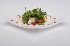 Salad in a white plate on a white background Product Image 1