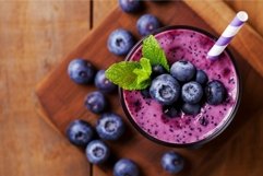 Fresh blueberry smoothie on wooden background Product Image 1
